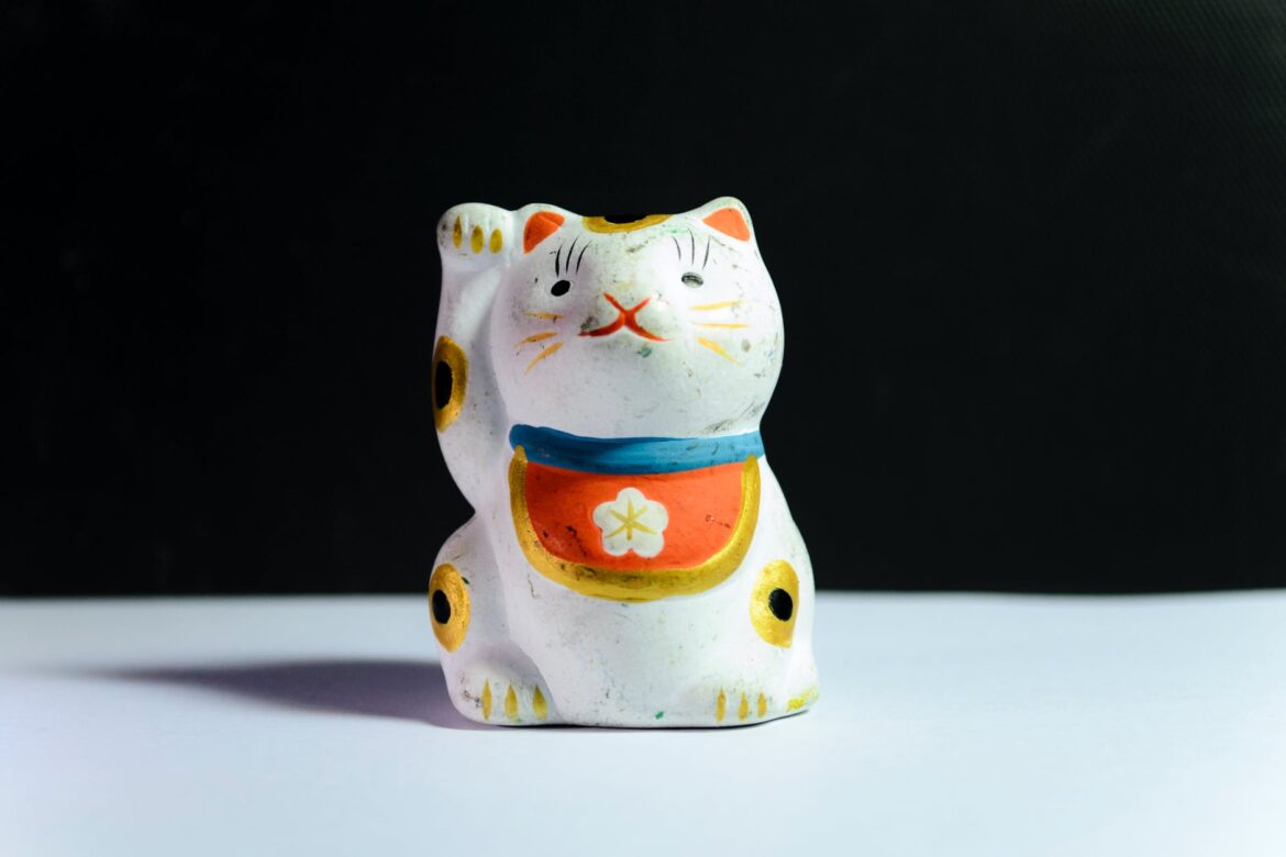 maneki neko figurine on white surface